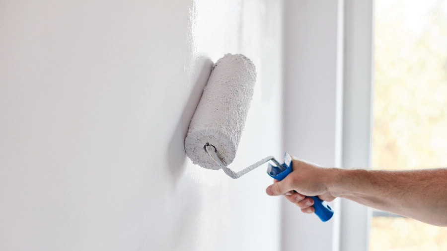 contractor with a paint roller during an interior painting sioux city ia